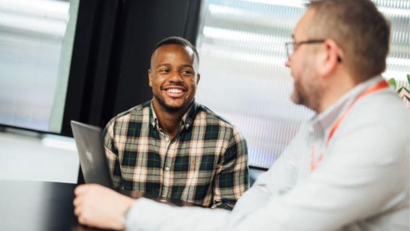 student sitting at a table talking with a careers consultant